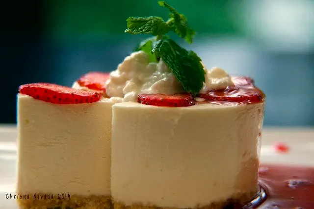 Strawberry cheesecake with whipped cream and mint