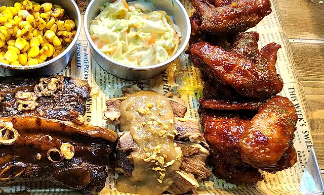Ribs, roast beef and wings platter with corn and coleslaw
