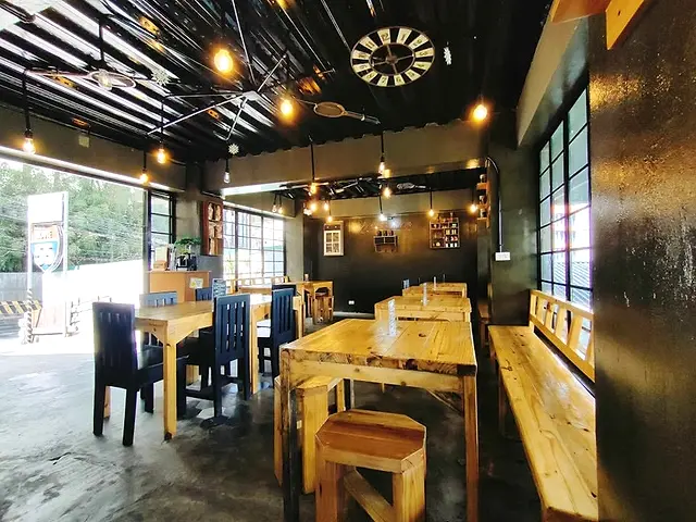 Route 55 dining hall with wooden tables and industrial lights